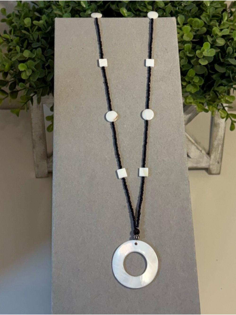 Black Bead Necklace with White Mother-of-Pearl Ring Pendant